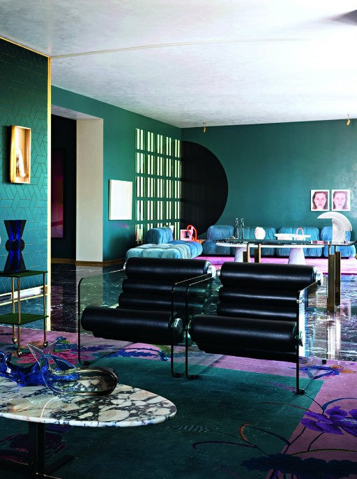 Cover of Architectural Digest magazine featuring a modern interior design with a red chair and teal walls.
