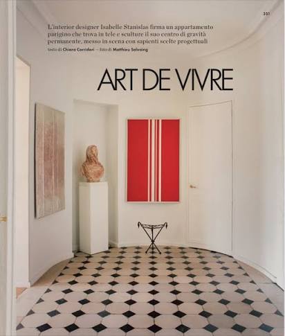 Front cover of ELITE DECOR ITALIA magazine featuring a modern interior scene with a glass table, black chairs, a warm yellow pendant light, and the headline 'SENSORY DESIGN'.