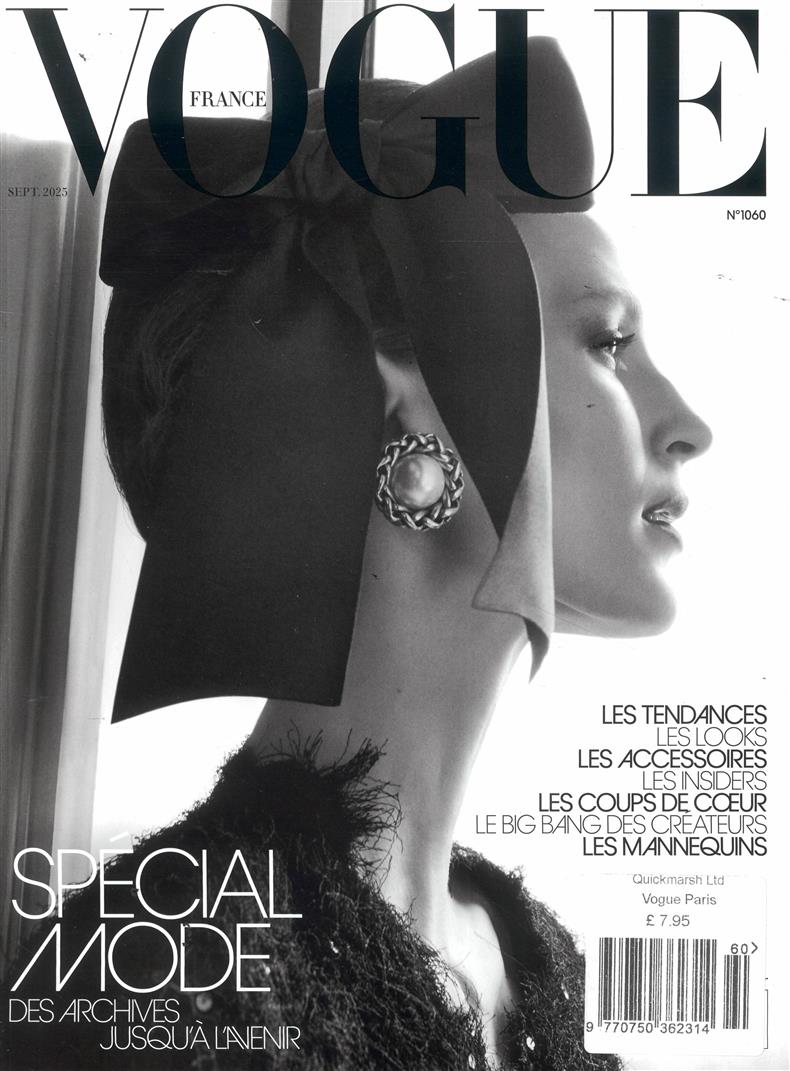 Vogue France magazine cover with a woman wearing a black headpiece and earring.