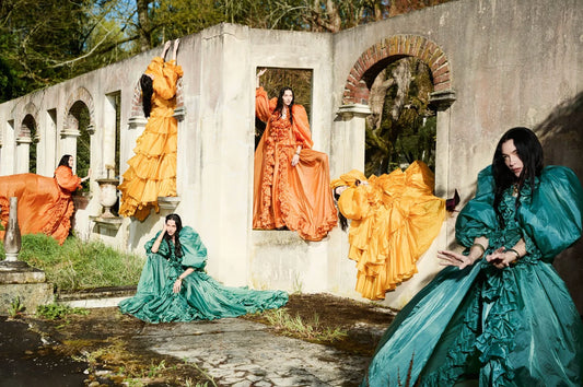 Vogue Italia magazine cover featuring Mariacarla in a dramatic pleated orange sleeveless gown.
