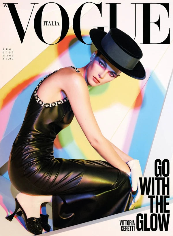 Vogue Italia magaine cover with Victtoria Ceretti in black dress and hat kneeling.