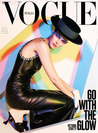 Vogue Italia magaine cover with Victtoria Ceretti in black dress and hat kneeling.