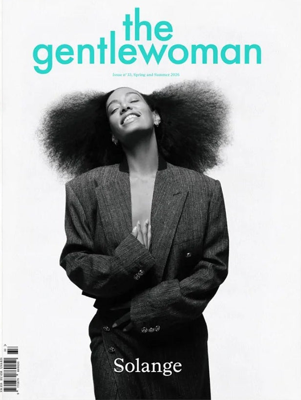 Solange smiling in a suit on the cover of The Gentlewoman