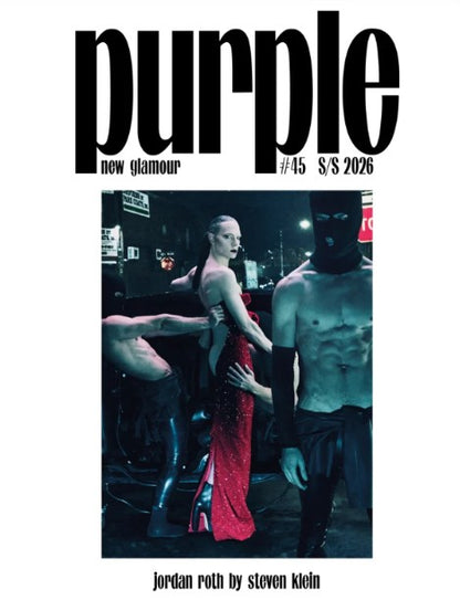 Front cover of the Spring/Summer 2026 issue of Purple magazine, featuring the bold black title 'purple' at the top and a central fashion photograph with a model in a red dress and another figure in a black mask, on a white background.
