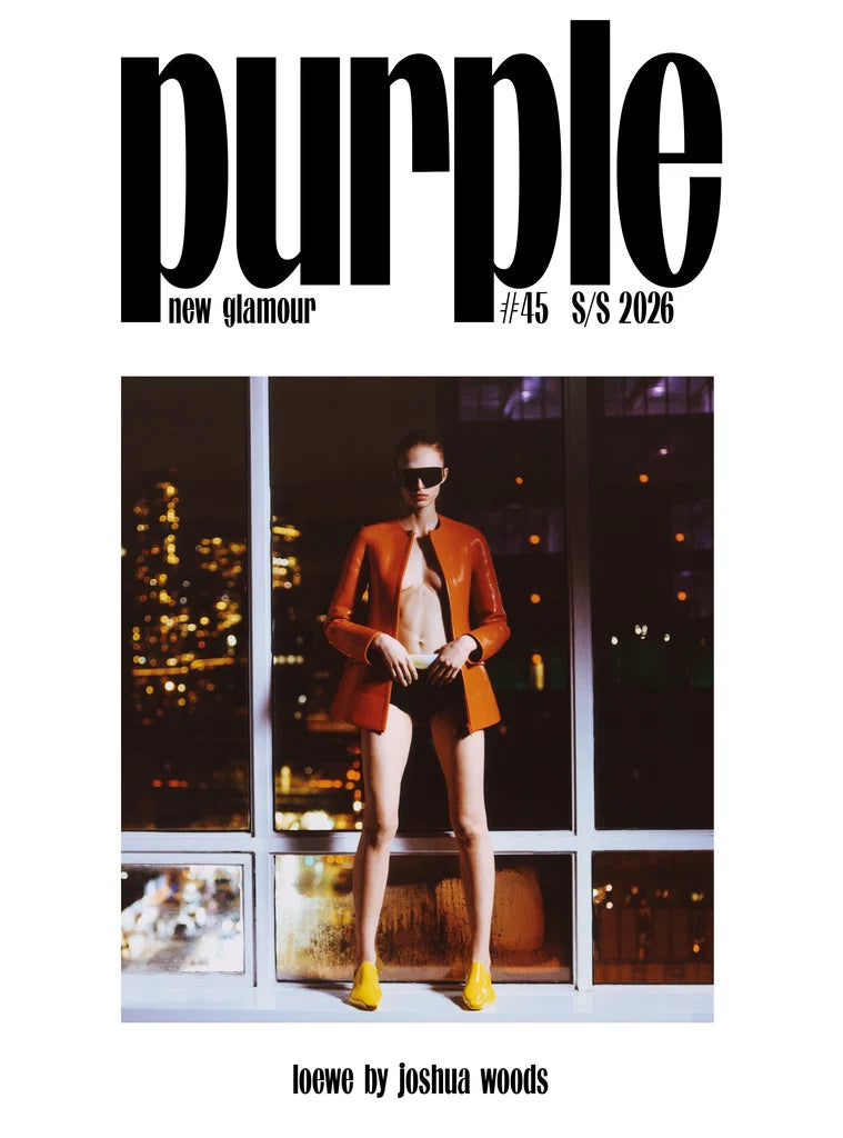 Magazine cover with a person in an orange jacket against a cityscape background, featuring the text 'Purple new glamour #45 S/S 2026'.