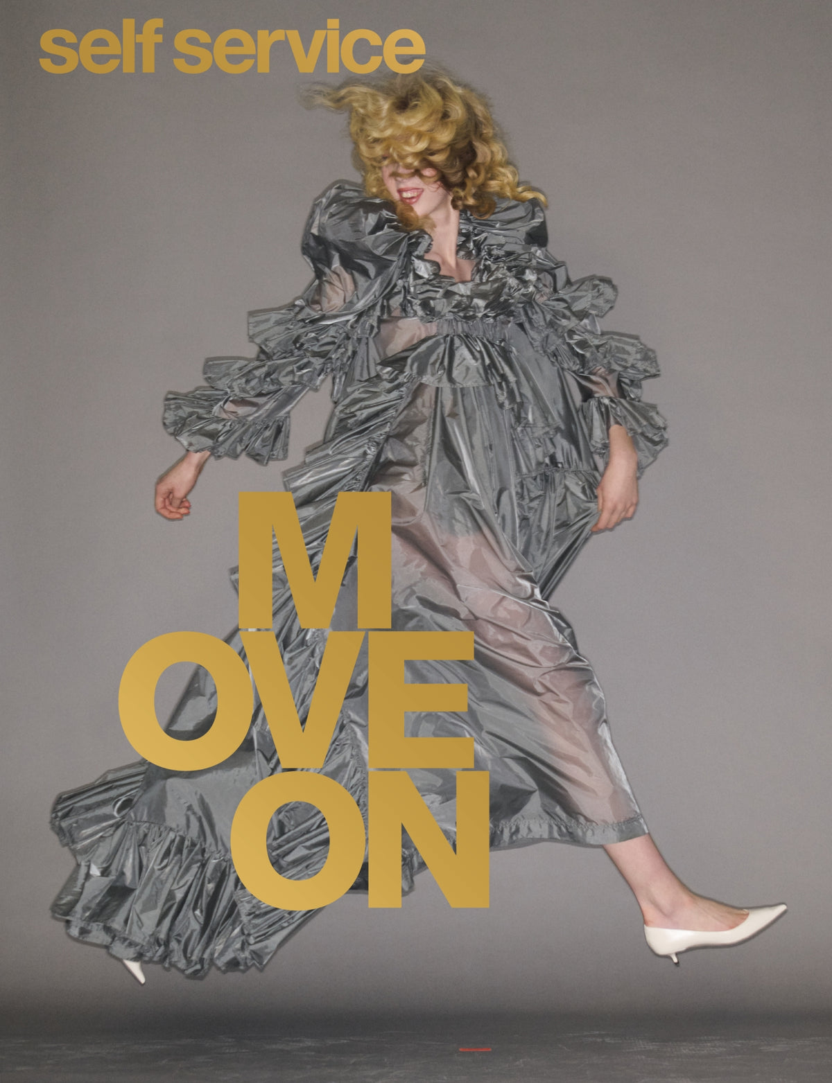 Woman on cover og magazine wearing grey gown with grey background