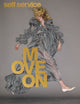 Woman on cover og magazine wearing grey gown with grey background