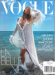 Vogue magazine cover featuring Gisele Bundchen in a white dress by the ocean