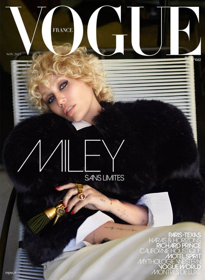 Vogue magazine cover featuring Miley Cyrus in a black fur coat sitting down.