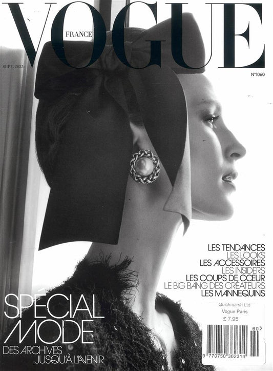 Vogue France magazine cover with a woman wearing a black headpiece and earring.