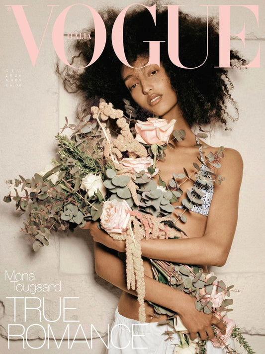 Mono Tougaard on Vogue Italia Magazine wearing bikini holding bouquet leaning on blank wall.